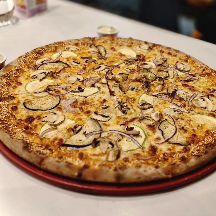 Mushroom and aubergine pizza on a red tray